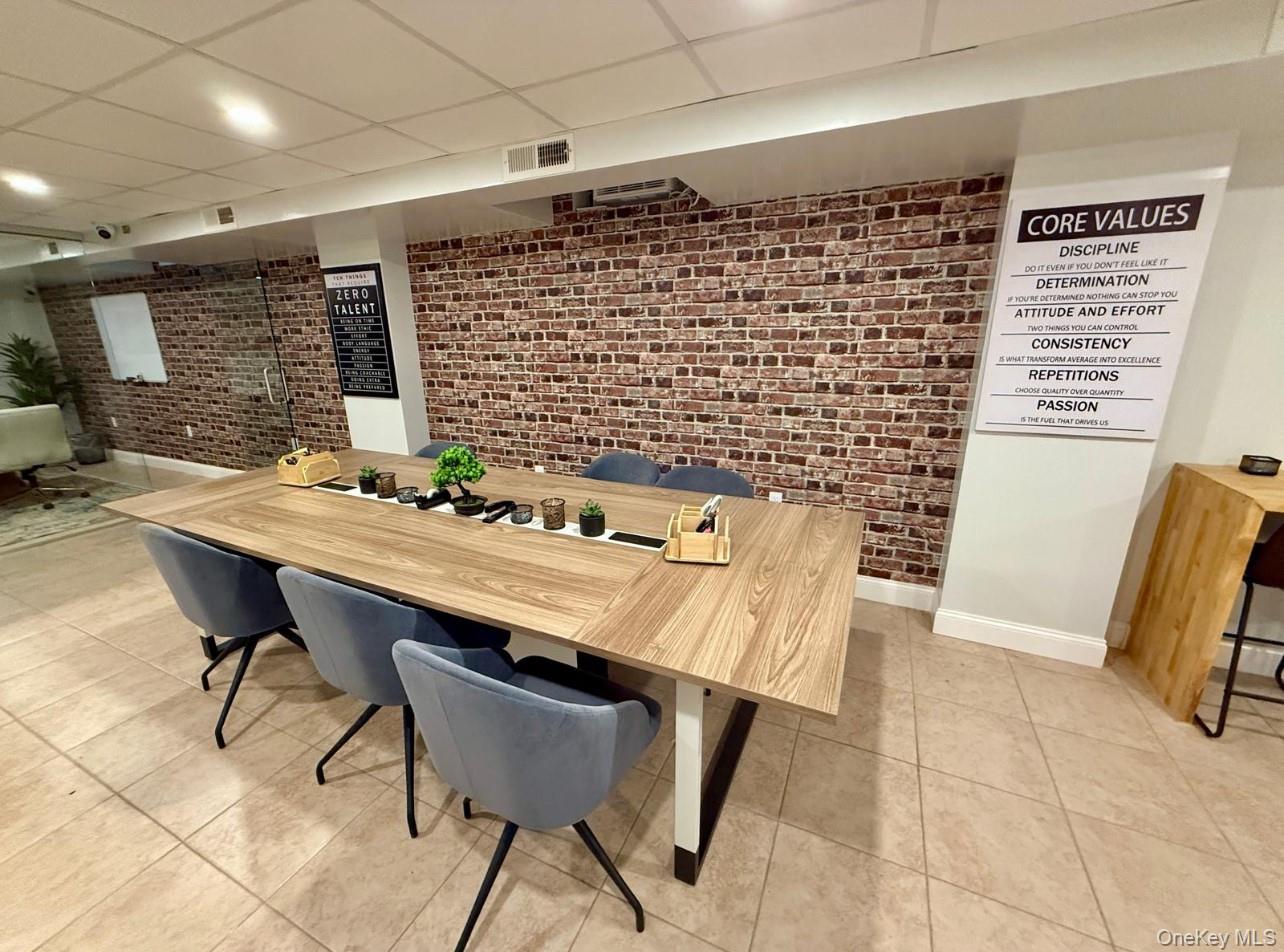 230 Pelham Road, Unit 2E New Rochelle, NY 10805 - Photo 20 of 31 Dining room with brick wall, a drop ceiling, light tile patterned floors, and recessed lighting