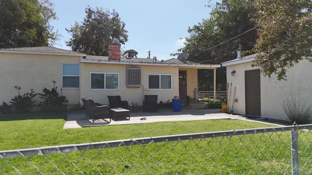 a front view of house with yard and outdoor seating
