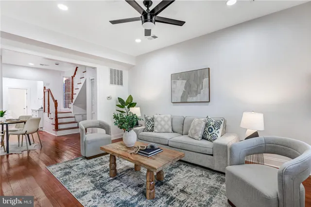 a living room with furniture a rug and a chandelier