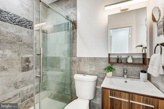 a bathroom with a sink toilet and shower
