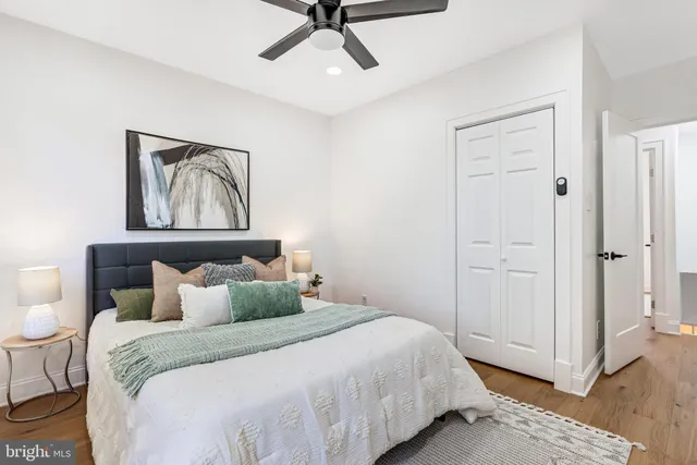 a bedroom with a bed and painting on the wall