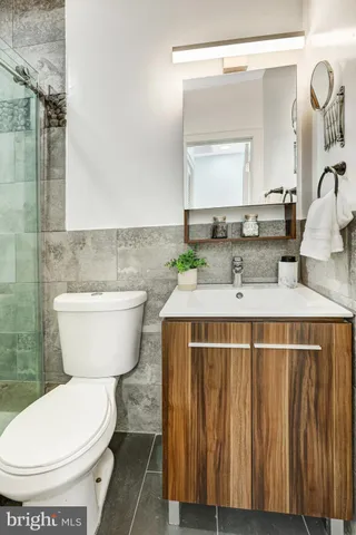 a bathroom with a toilet sink and mirror