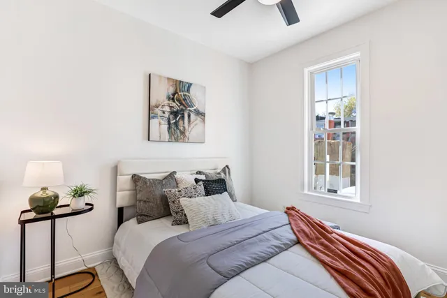 a bedroom with a bed and a window