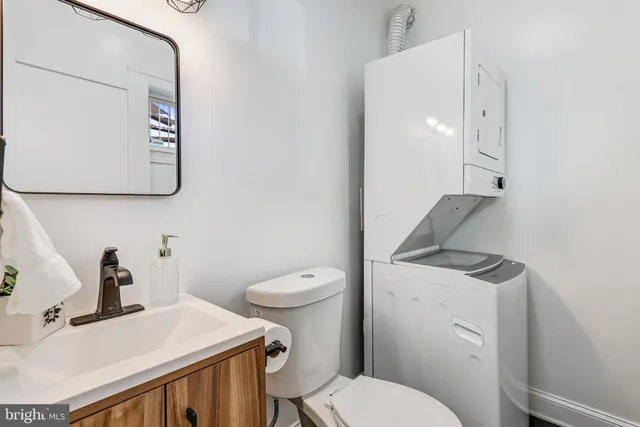 a bathroom with a toilet a sink and mirror
