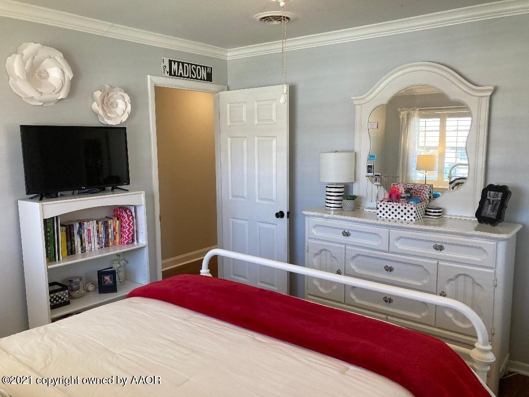 6717 Jameson Road Amarillo, TX 79106 - Photo 50 of 72 a bedroom with a bed and a flat screen tv