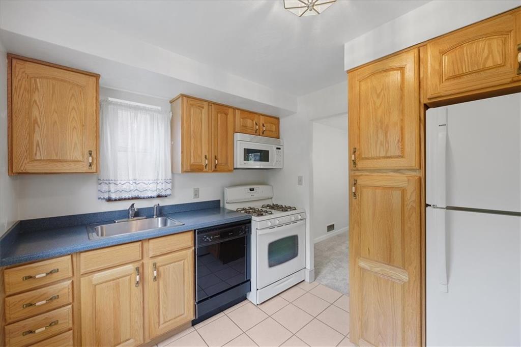 620 Beulah Road Pittsburgh, PA 15235 - Photo 11 of 25 a kitchen with stainless steel appliances granite countertop a refrigerator sink and cabinets