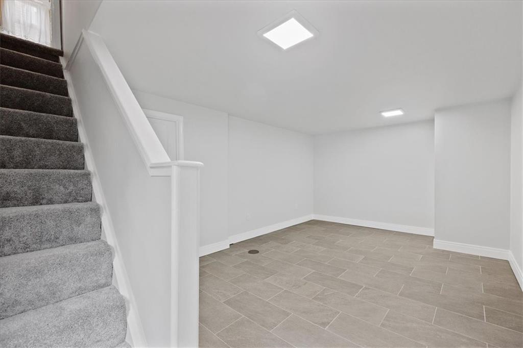 620 Beulah Road Pittsburgh, PA 15235 - Photo 21 of 25 an empty room with stairs and white walls