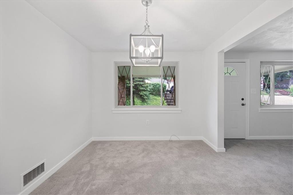 620 Beulah Road Pittsburgh, PA 15235 - Photo 7 of 25 an empty room with windows and outdoor view