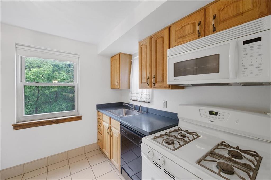 620 Beulah Road Pittsburgh, PA 15235 - Photo 9 of 25 a kitchen with a stove a sink and a microwave