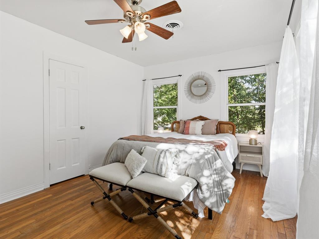 3804 Pershing Avenue Fort Worth, TX 76107 - Photo 12 of 31 a bedroom with a bed and wooden floor