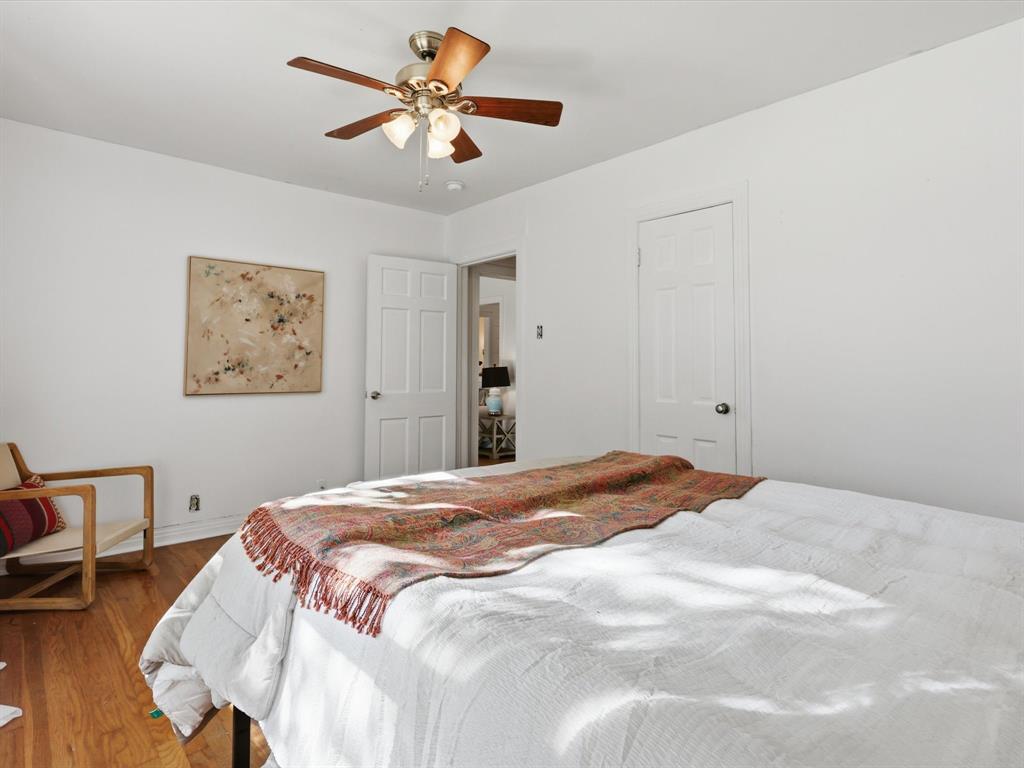 3804 Pershing Avenue Fort Worth, TX 76107 - Photo 13 of 31 a bedroom with a bed and a chandelier