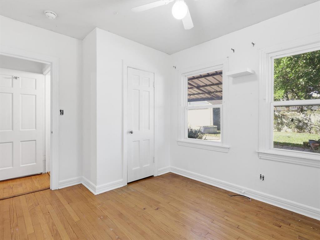 3804 Pershing Avenue Fort Worth, TX 76107 - Photo 18 of 31 an empty room with wooden floor and windows