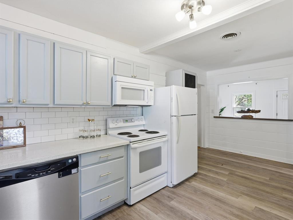 3804 Pershing Avenue Fort Worth, TX 76107 - Photo 9 of 31 a kitchen with white cabinets and white appliances