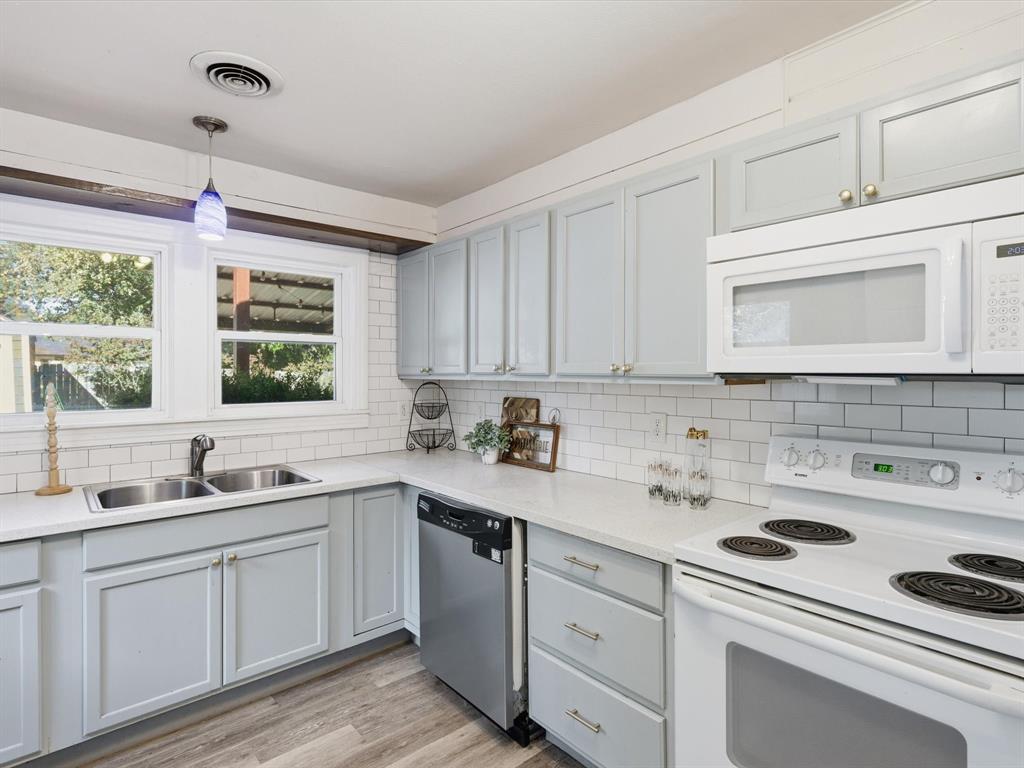 3804 Pershing Avenue Fort Worth, TX 76107 - Photo 10 of 31 a kitchen with a sink dishwasher window and cabinets