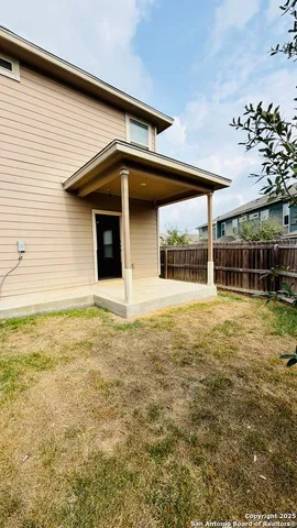 a view of a swimming pool with an outdoor seating and a yard