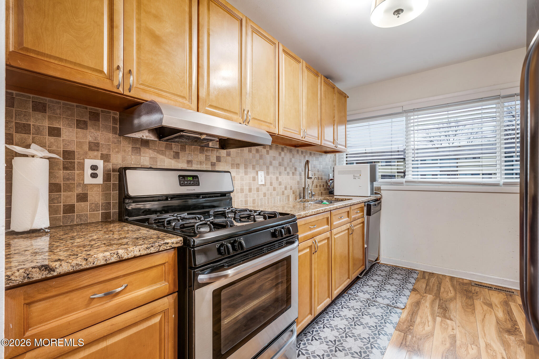 433 Bolton Road East Windsor, NJ 08520 - Photo 2 of 13 a kitchen with granite countertop wooden cabinets and a stove top oven