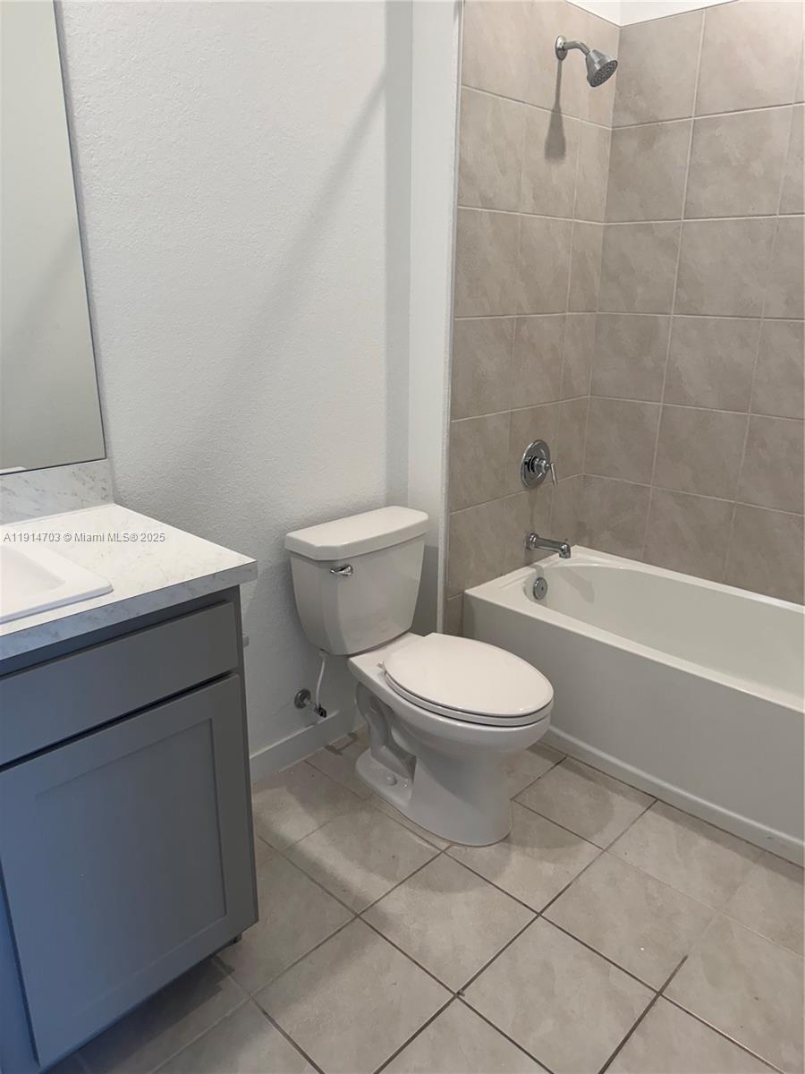 817 Northwest 3rd Way, Unit 817 Pompano Beach, FL 33060 - Photo 12 of 13 a bathroom with a toilet a sink and a bath tub