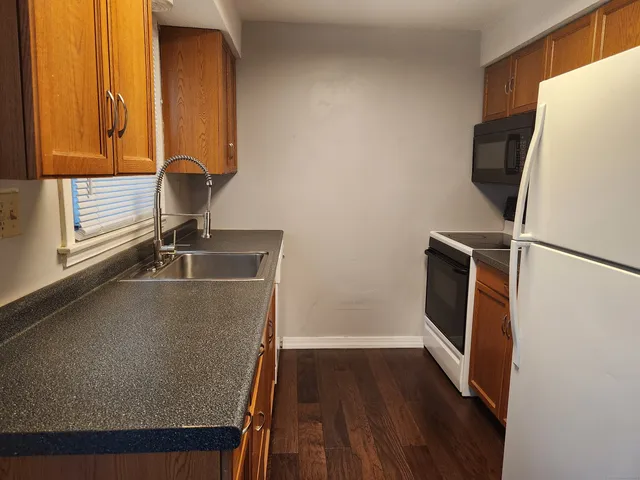 a view of a storage and utility room with wooden floor