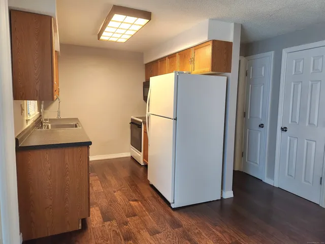 a utility room with wooden floor and a window