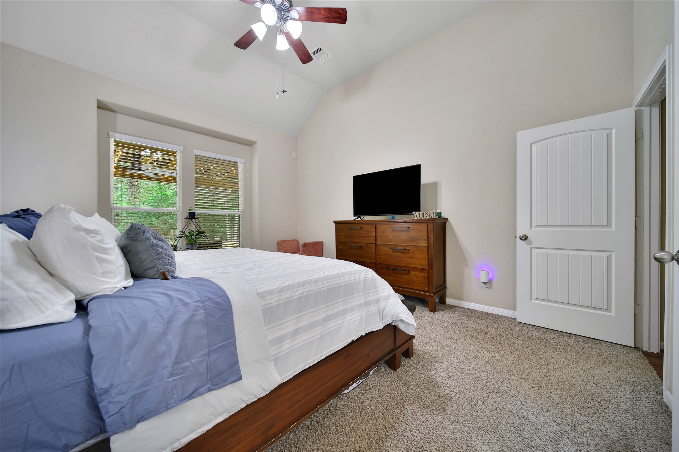 9223 Wapiti Trail Conroe, TX 77303 - Photo 25 of 45 a bedroom with a bed and a flat screen tv