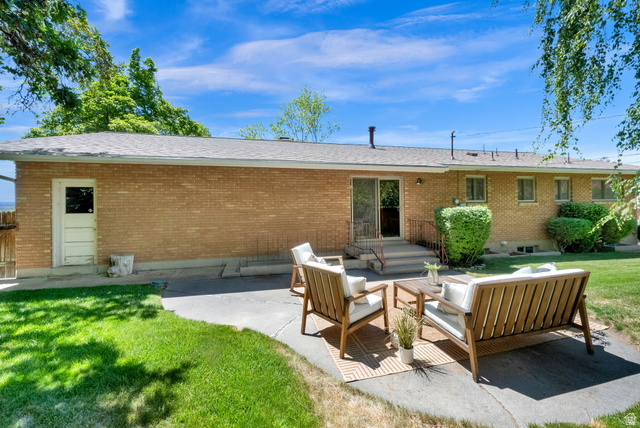 1783 South 500 East Bountiful, UT 84010 - Photo 21 of 30 Expansive backyard featuring a manicured lawn, established shade trees, and a concrete patio