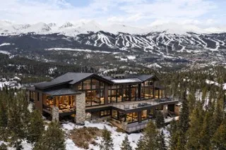 a view of a big house with swimming pool and sitting area