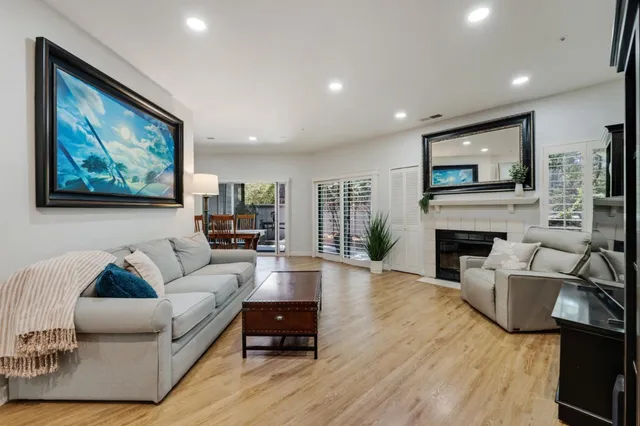 a living room with furniture a fireplace and a flat screen tv