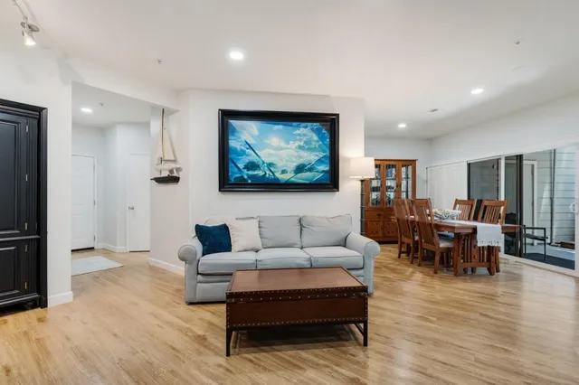 a living room with furniture and wooden floor