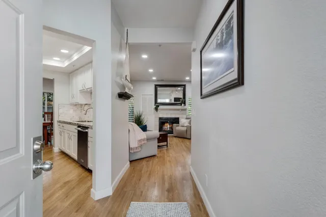 a view of a living room with furniture and wooden floor