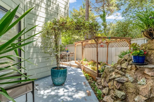 a view of a balcony with chair and potted plants