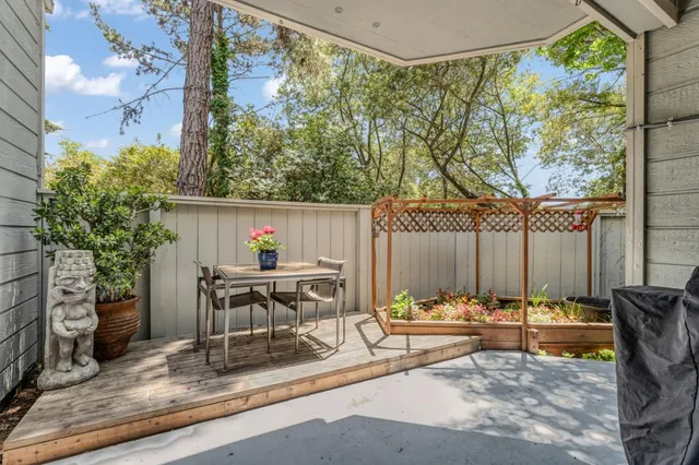 a view of a patio with table and chairs and potted plants