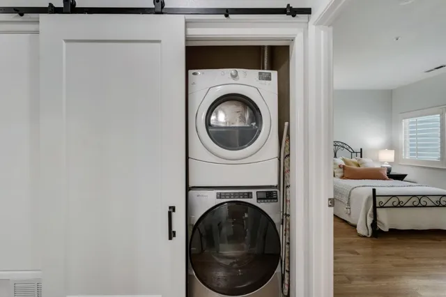 a view of a bedroom with washer and dryer