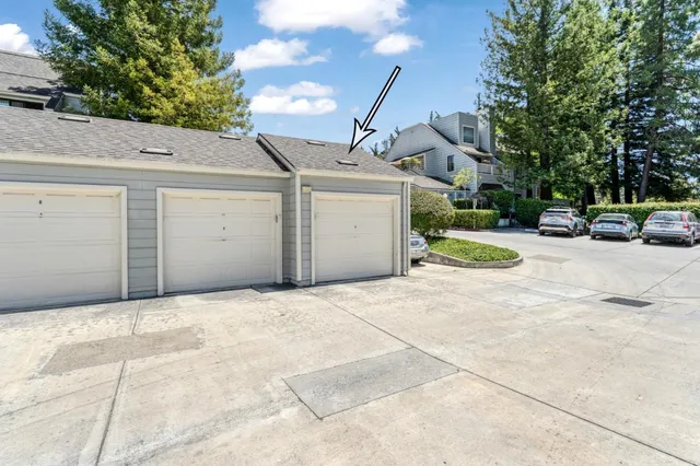 a view of a parking space in front of a house