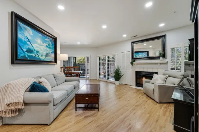 a living room with furniture a fireplace and a flat screen tv
