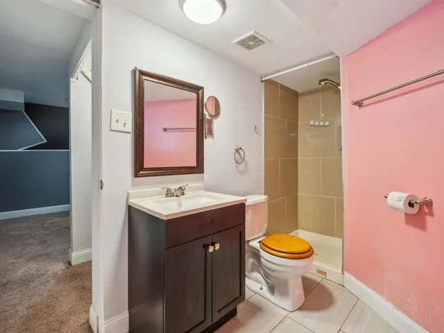a view of a small house in the park with wooden fence