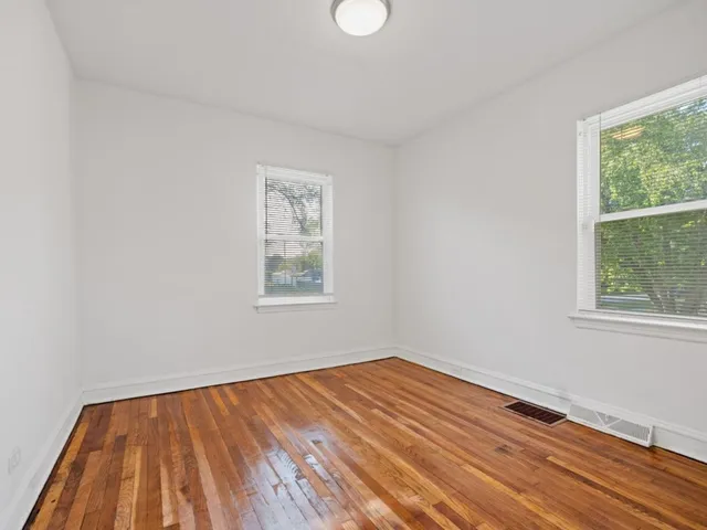 a view of a room with wooden floor and window