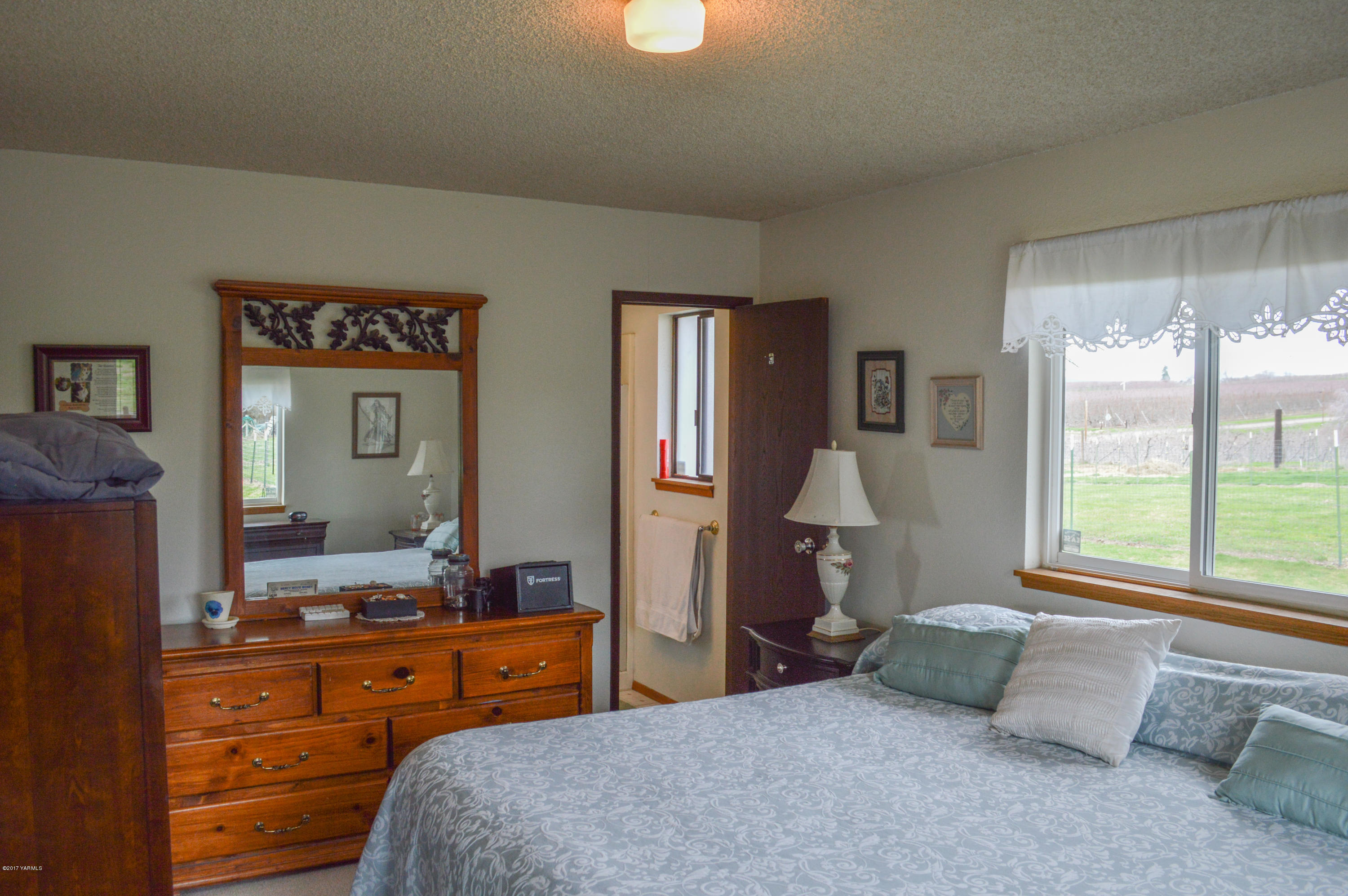581 Gilbert Road Zillah, WA 98953 - Photo 11 of 38 a bedroom with a bed and wooden floor
