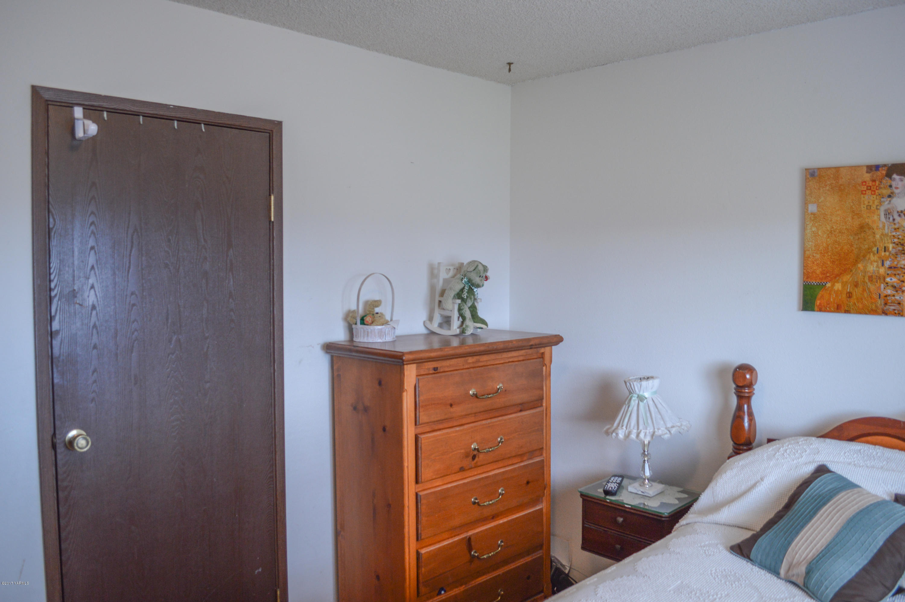 581 Gilbert Road Zillah, WA 98953 - Photo 15 of 38 a bedroom with a bed and wooden floor