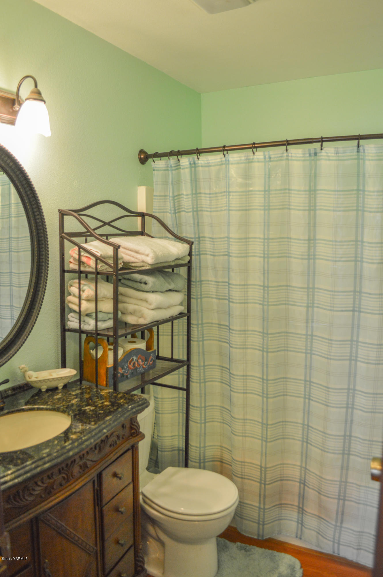 581 Gilbert Road Zillah, WA 98953 - Photo 19 of 38 a bathroom with a granite countertop sink and a mirror