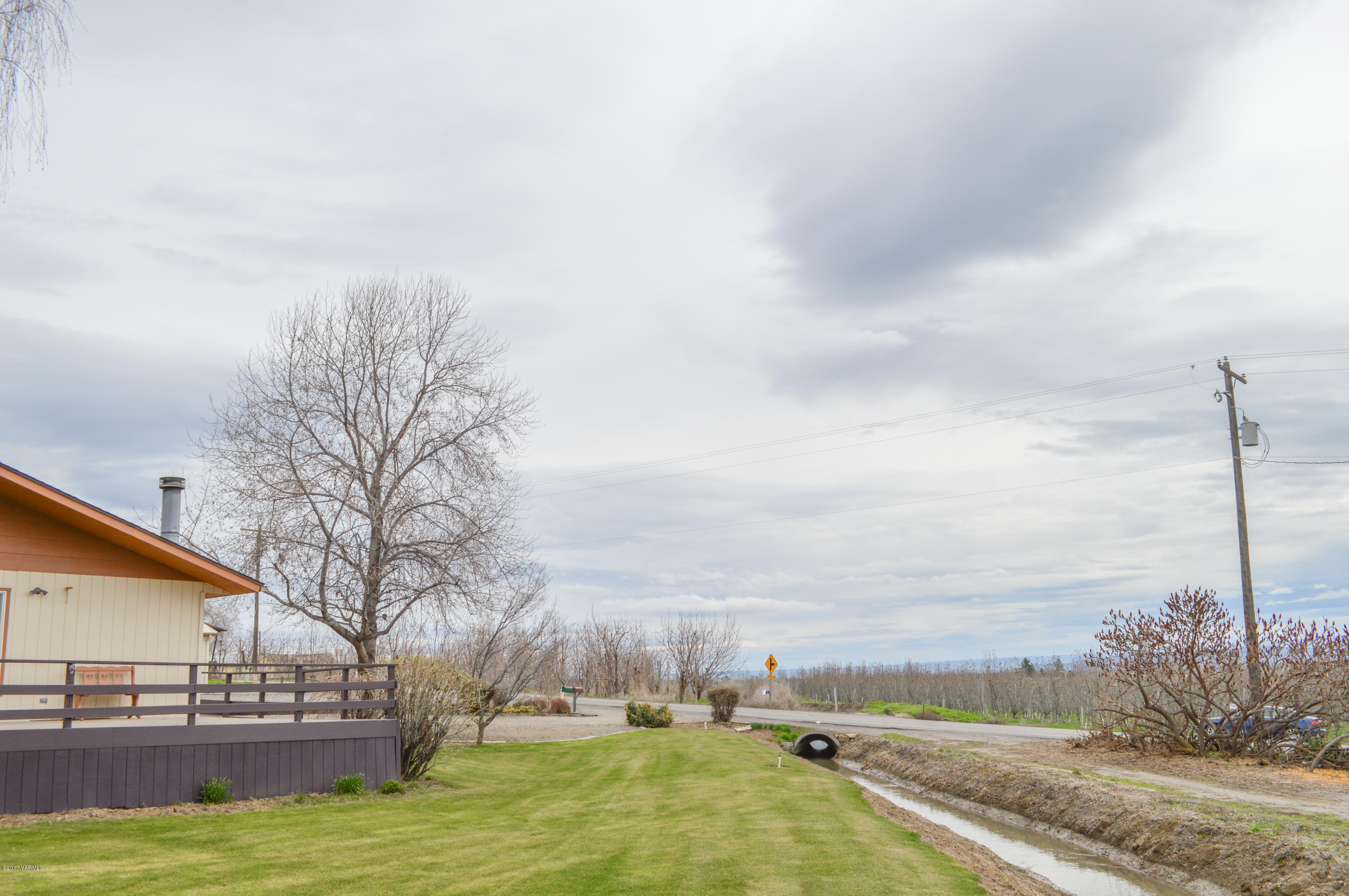 581 Gilbert Road Zillah, WA 98953 - Photo 32 of 38 a view of yard with swimming pool and trees in the background