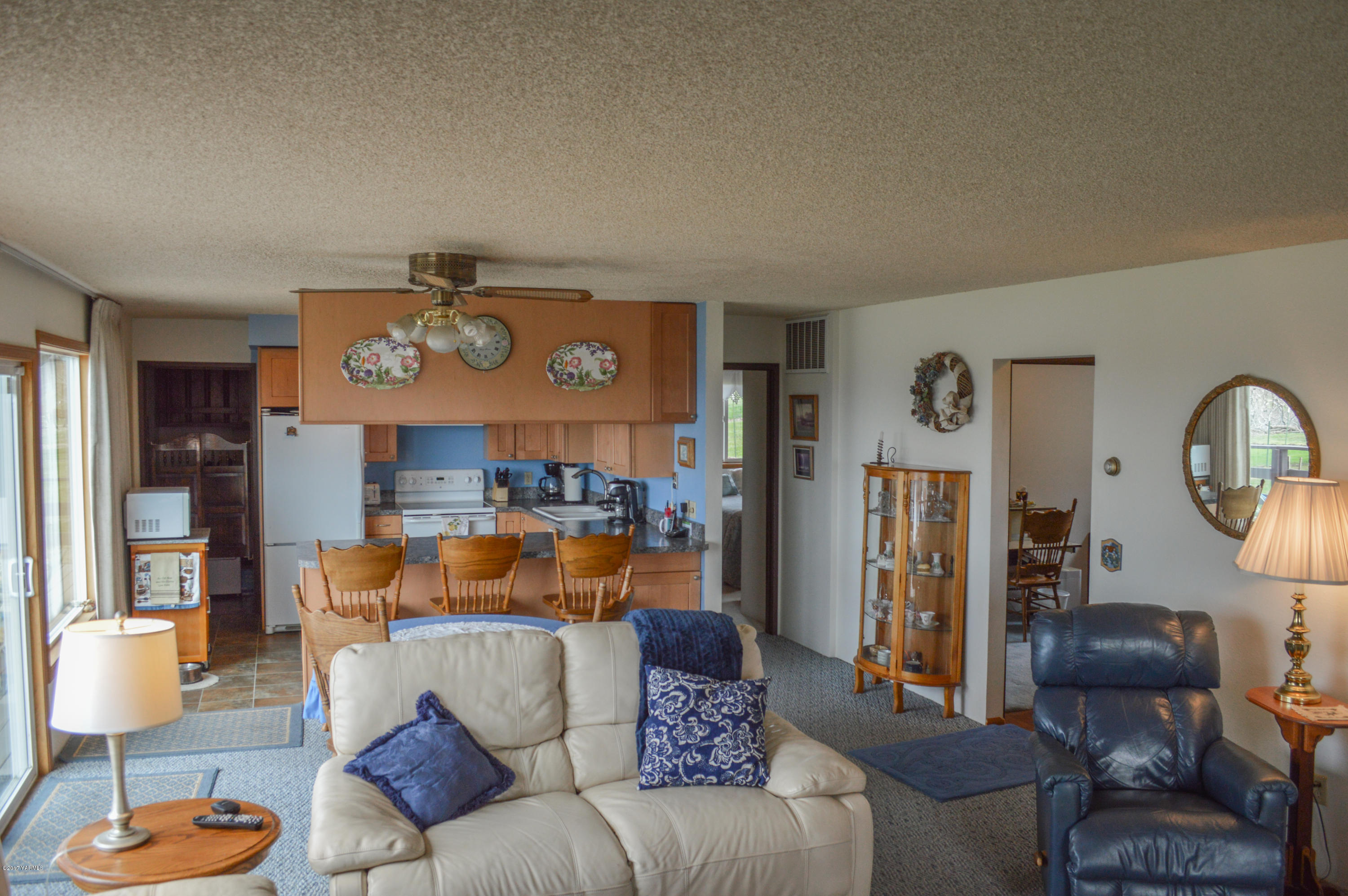 581 Gilbert Road Zillah, WA 98953 - Photo 5 of 38 a living room with furniture and a clock