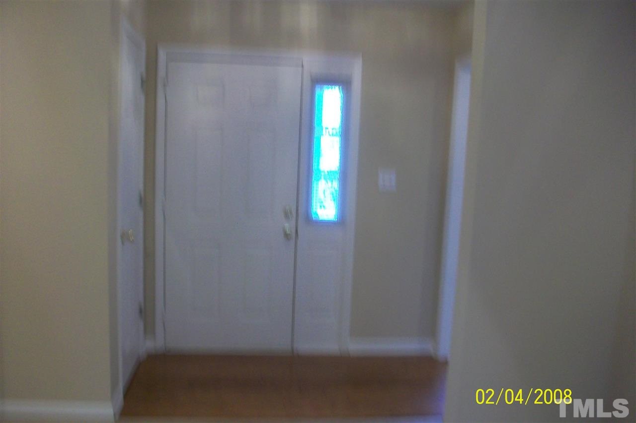 Looking from living/family room into foyer and front entrance.