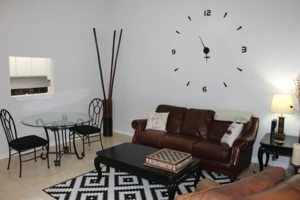 a living room with furniture a rug and a window