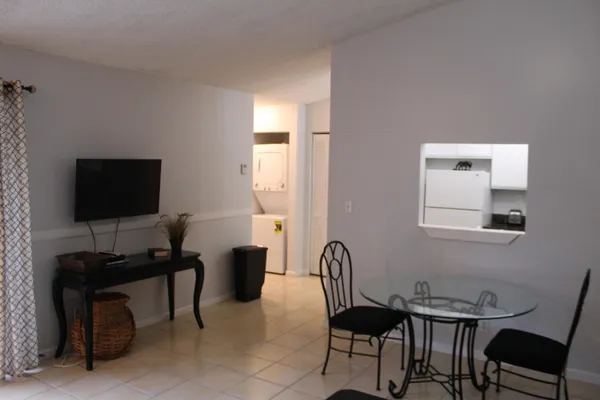 a white kitchen with a stove a sink and dishwasher