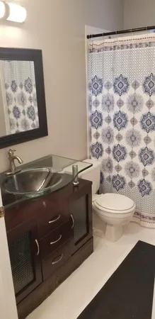 a bedroom with a bed and a lamp