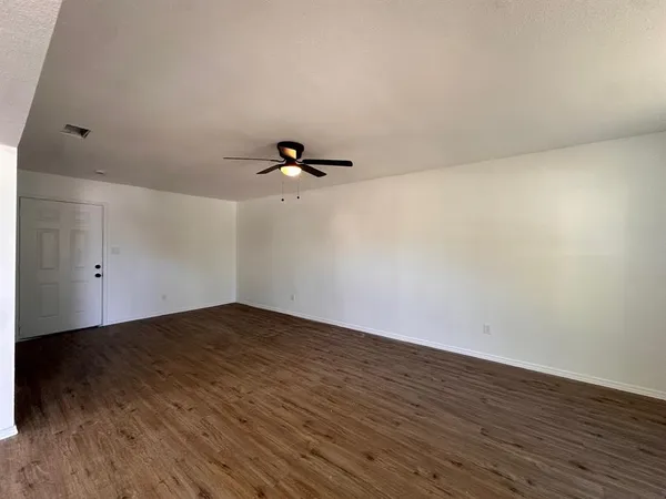a view of a room with wooden floor