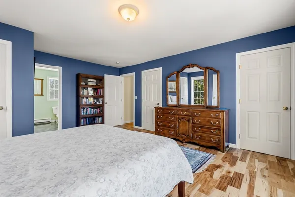 a bedroom with a bed and a dresser