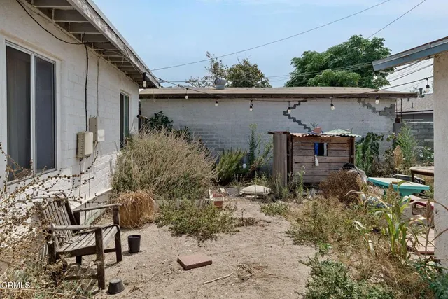 a backyard of a house with yard and outdoor seating