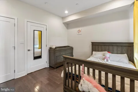 a bedroom with furniture and baby crib