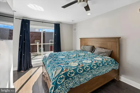 a bedroom with a bed and large window